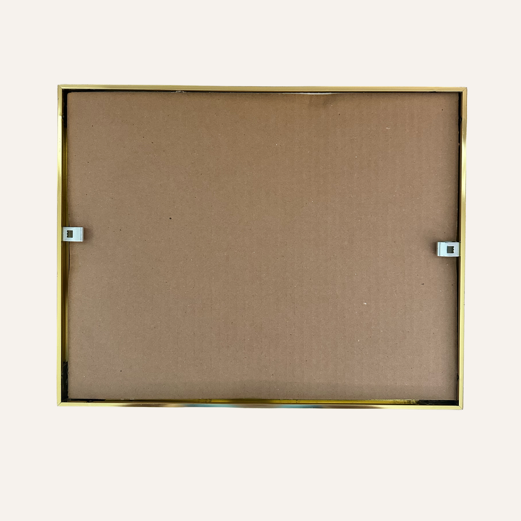 The back view of a square picture frame with a thin gold metal border and a brown cardboard backing, shown against a plain off-white background for artwork reproduction of Inviting Valley. 