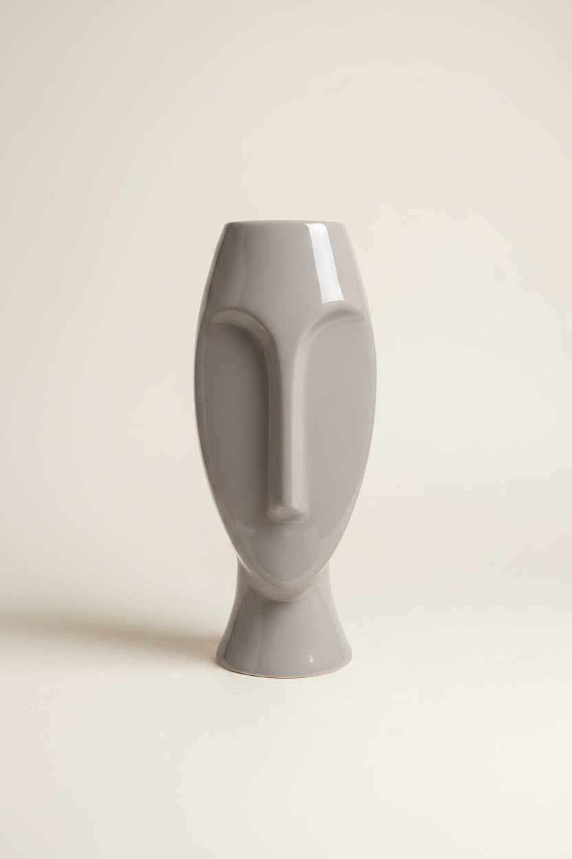Photo of a Pier 1 abstract face vase against an ivory backdrop. 