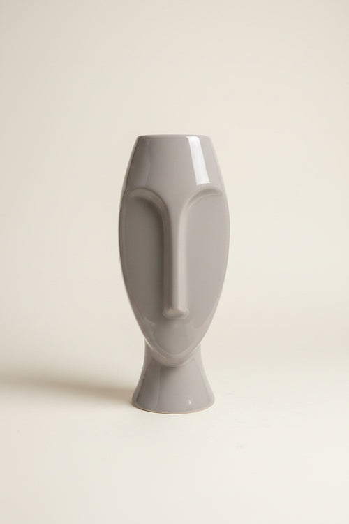 Photo of a Pier 1 abstract face vase against an ivory backdrop. 