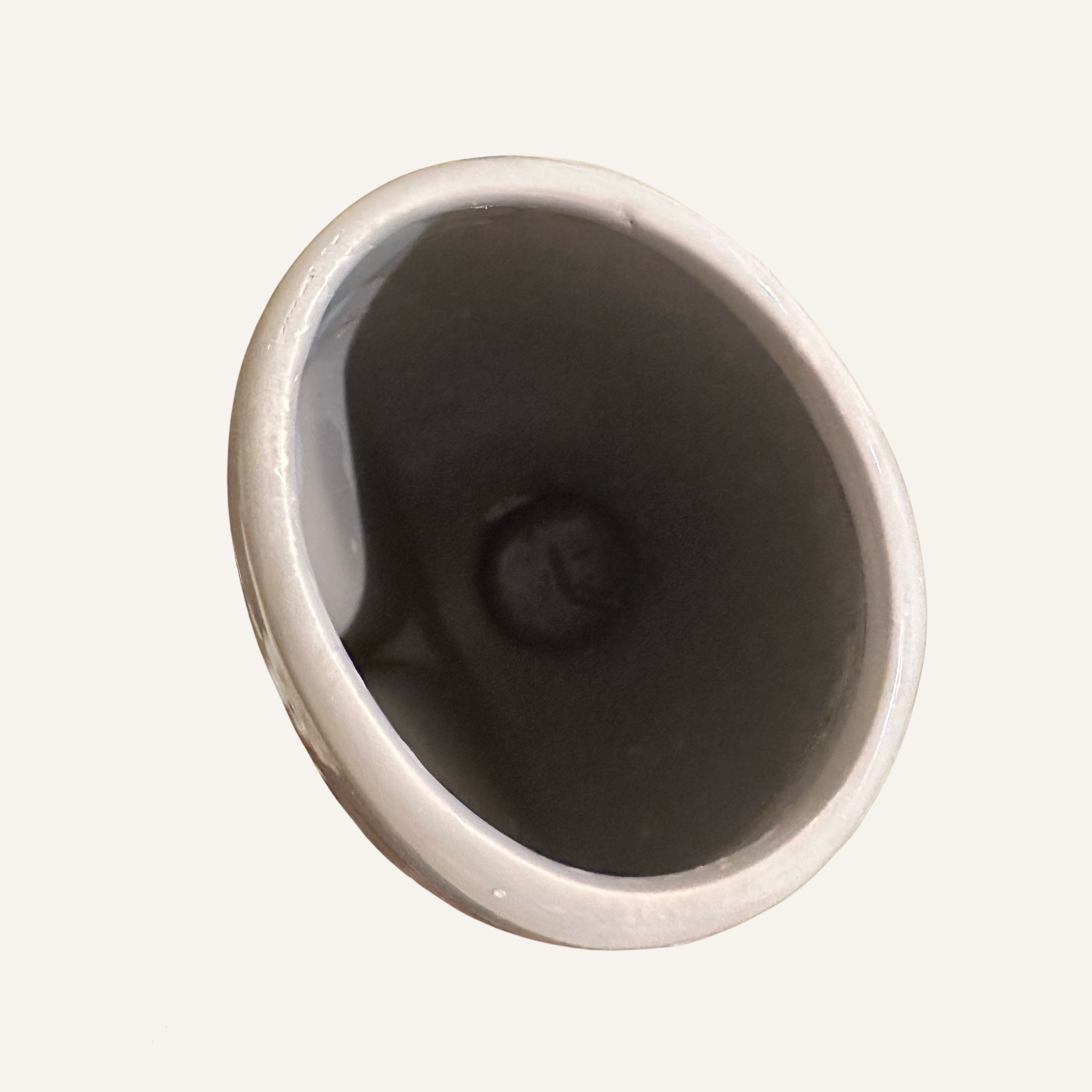 Top down view of an abstract sculptural modern art face vase from Pier 1. 